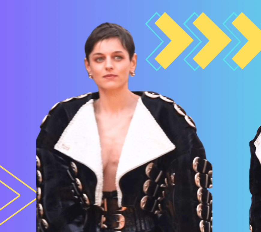 "Emma Corrin wearing a black leather bolero biker jacket with oversized shoulder straps, silver buckles, and contrasting white reverbs, paired with a waist-high belt/bustier, oversized black pants, pointed shoes, and Cartier jewelry at the 'Deadpool & Wolverine' premiere in London on July 11, 2024."